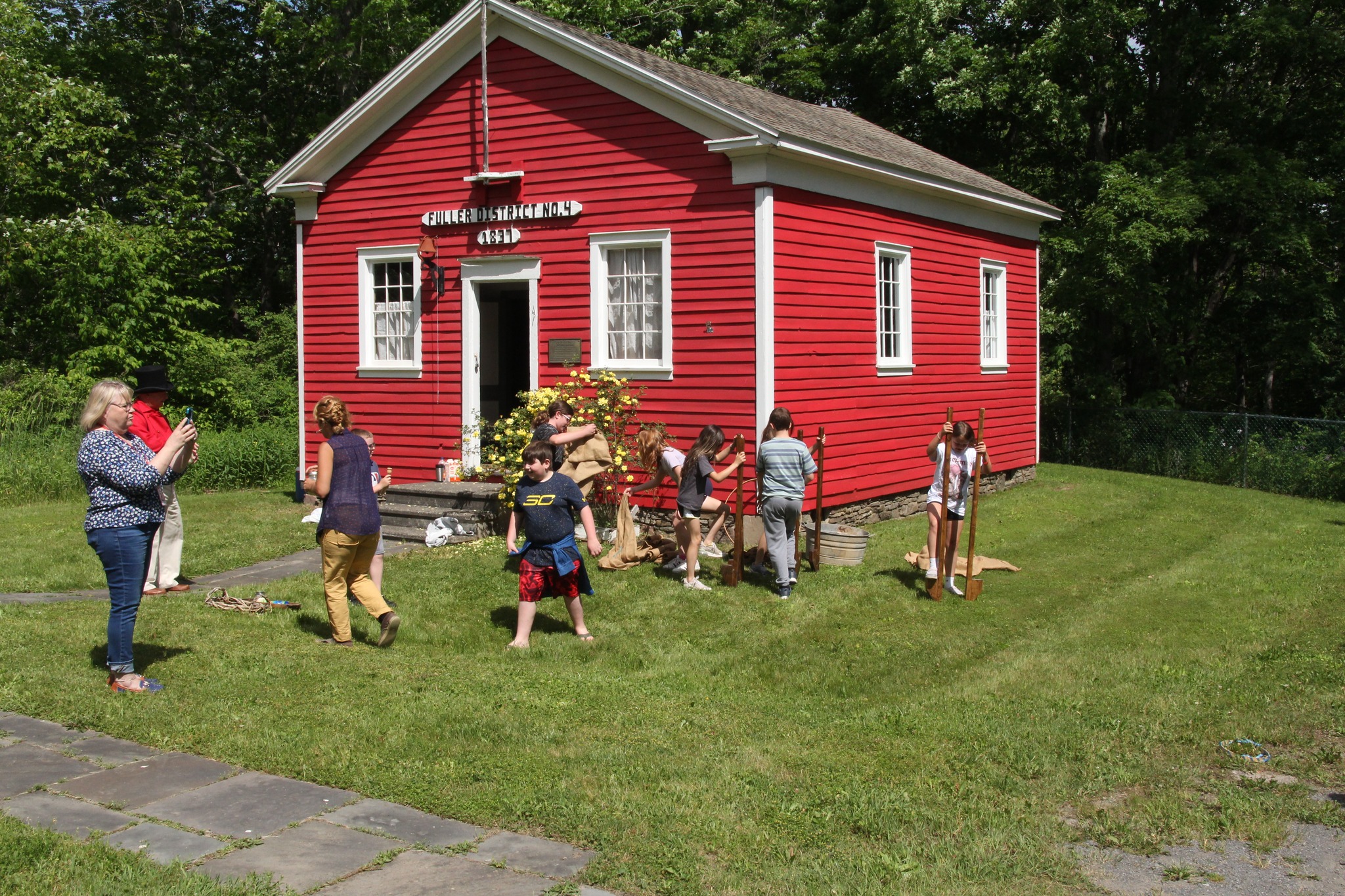 people outside red school house